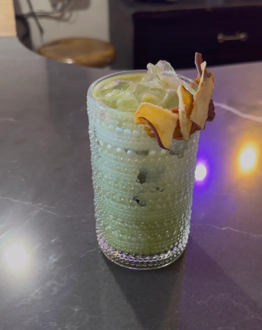 Iced apple spice matcha with a candied apple chip rim