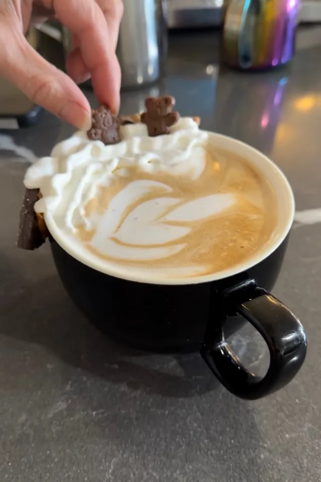 Cookie dough latte with whipped cream, teddy grahams and latte art