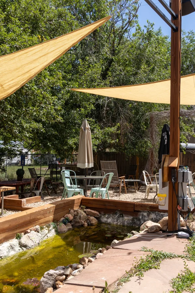 The back garden with shade sails and the koi pond