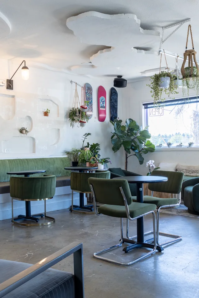 Seating by the roll-up garage door with skate decks above