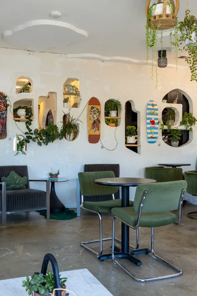 The room end to end: bar, seating, decks and plants