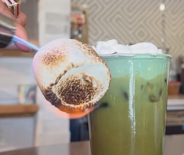 Iced matcha latte with a torched marshmallow