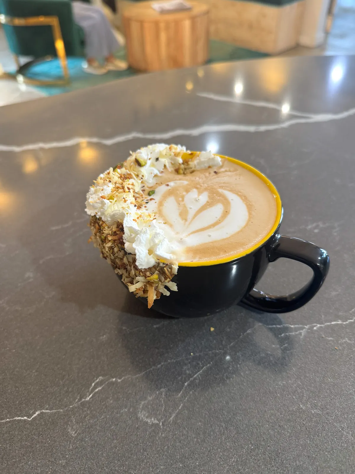 Pistachio–Coconut Latte. Toasted pistachio–coconut caramel rim, housemade pistachio–coconut syrup, whip, toasted flakes.