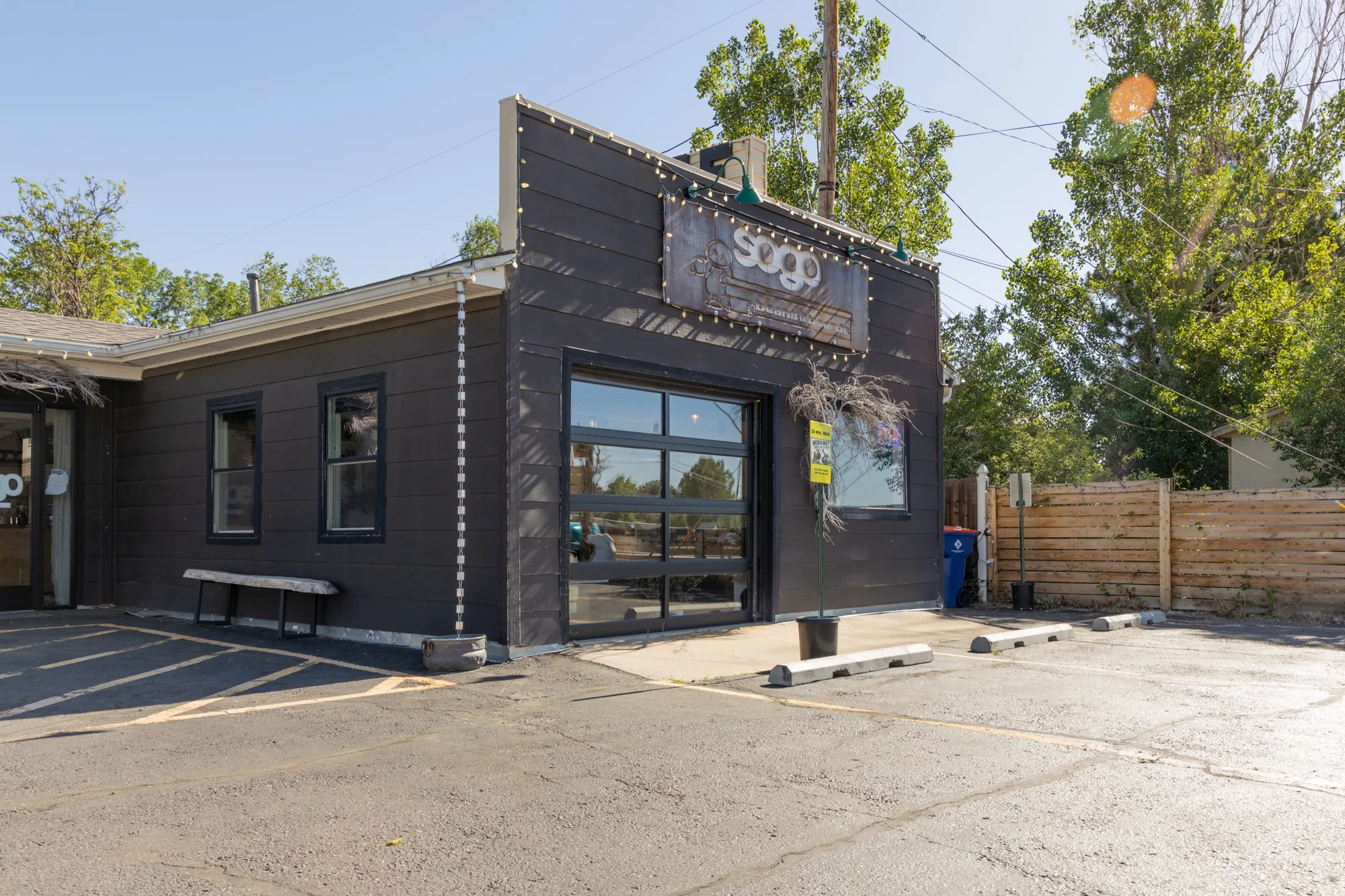 The SOGO Beans and Boards storefront on South Golden Road, a converted motorcycle garage with the bay door rolled up.