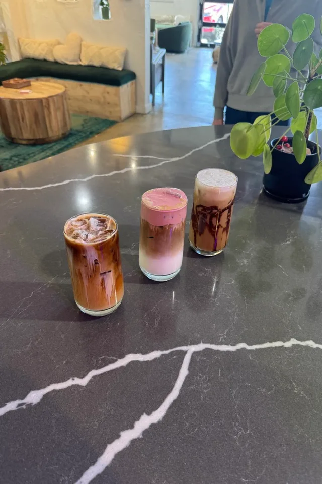 Three signature iced drinks lined up on the bar