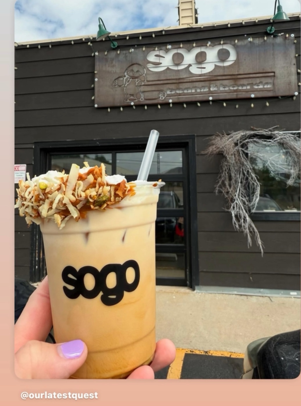 Coconut and pistachio iced latte in front of the Sogo storefront