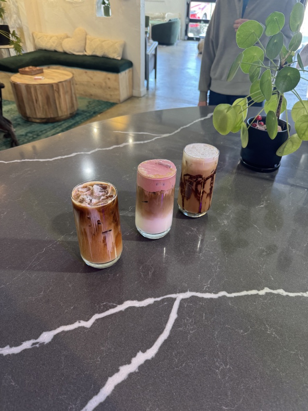 Three signature iced drinks lined up on the bar